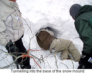 Tunnelling into the base of a snow mound
